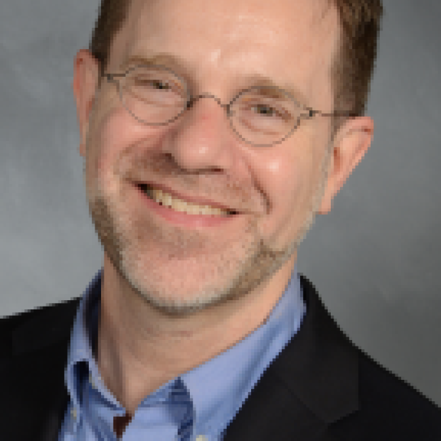 picture of Curtis, wearing a blue shirt and blazer