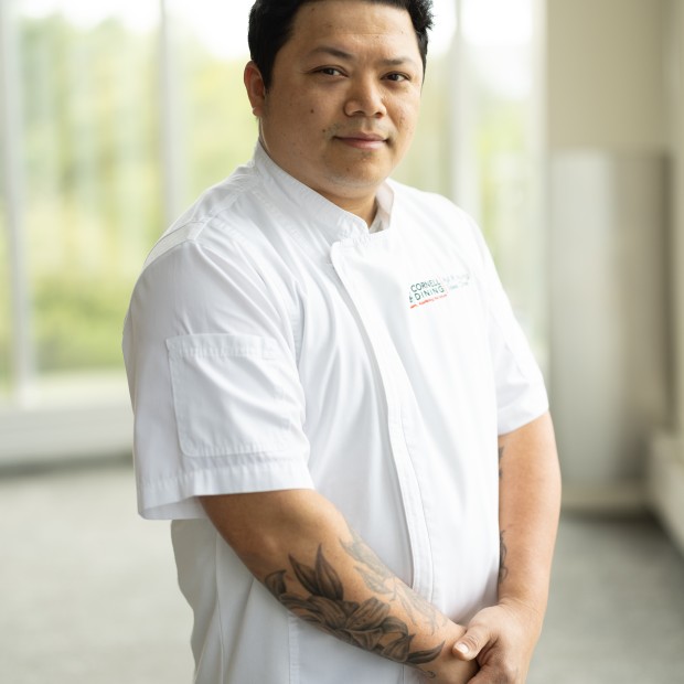 Chef Pyiphyo, wearing Chef coat, smiling