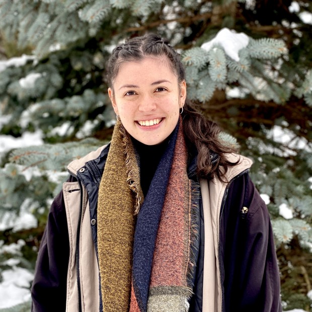 picture of Stephanie, standing outside in winter, wearing a coat and scarf