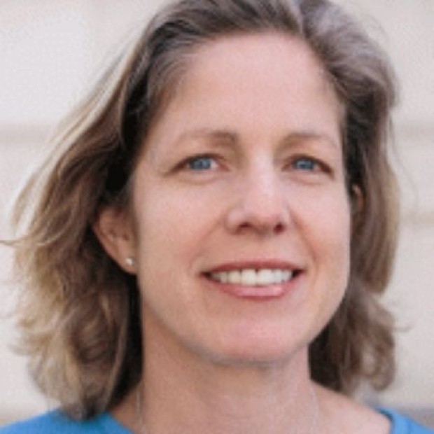 Person with shoulder-length hair wearing a blue top.