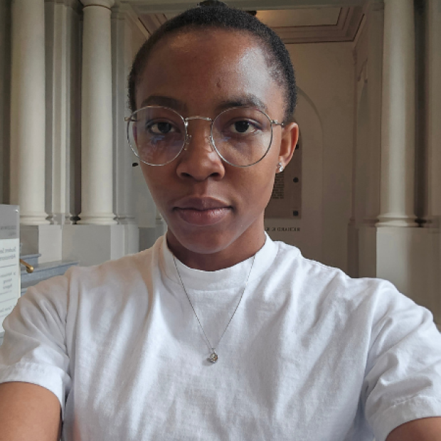 Esther, short hair, glasses, white t shirt