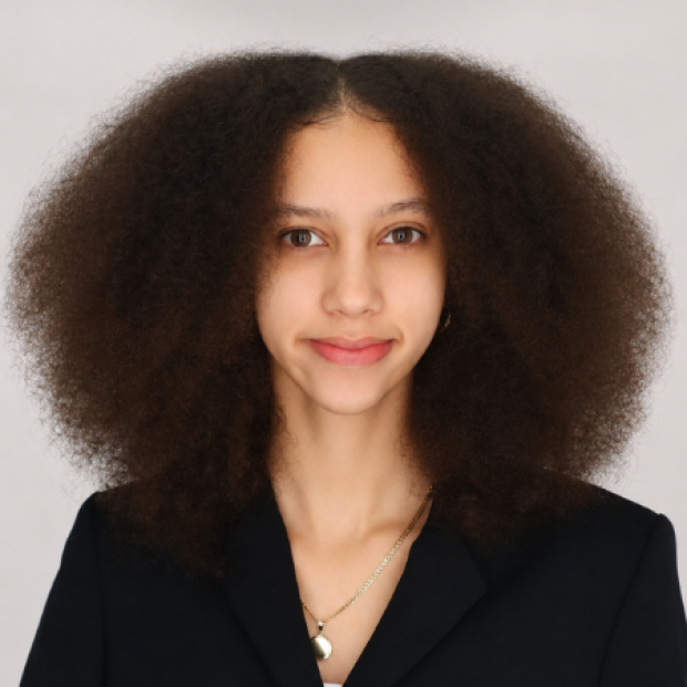 Mariam smiling in a black blazer