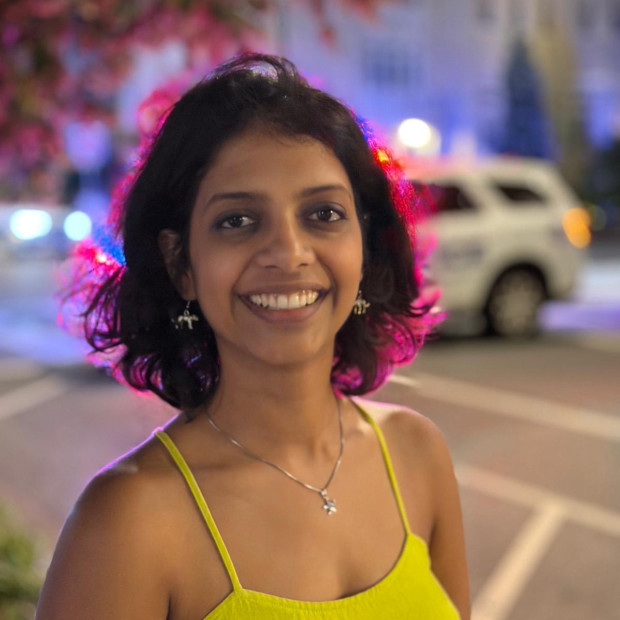 street-scape background, smiling, wearing a yellow tanktop