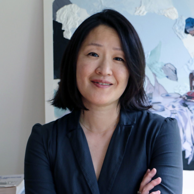 House Professor Dean Maria Park standing in front of painting. 