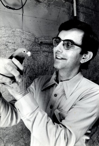 William Keeton smiling and holding pigeon