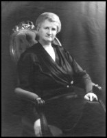 Black and white photo of Professor Flora Rose sitting in chair